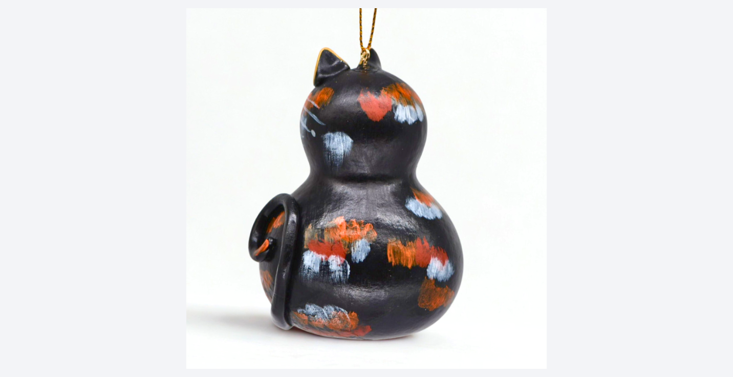 Handmade tortoiseshell cat ornament crafted from a natural gourd, hand painted with acrylics, 4 inches tall, ready to hang
