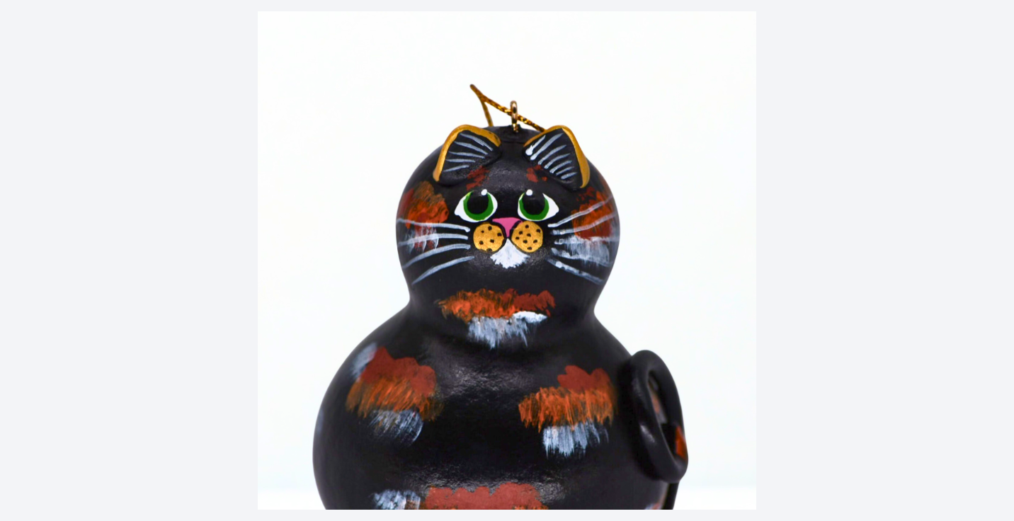 Handmade tortoiseshell cat ornament painted on natural gourd, inspired by a loyal cat companion
