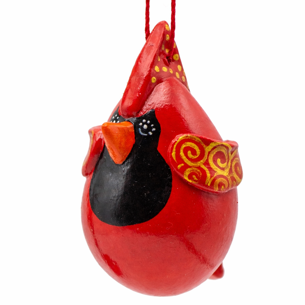 Red cardinal ornament with a yellow and red bow on a white background