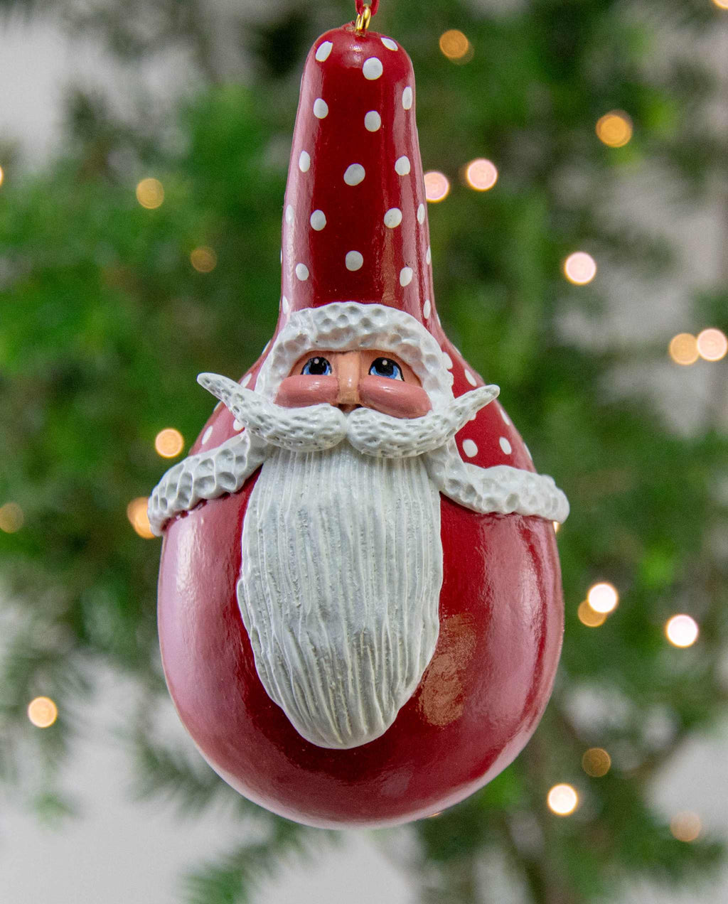 Handmade Santa gourd ornament with hand-painted face hanging on Christmas tree, unique holiday decor
