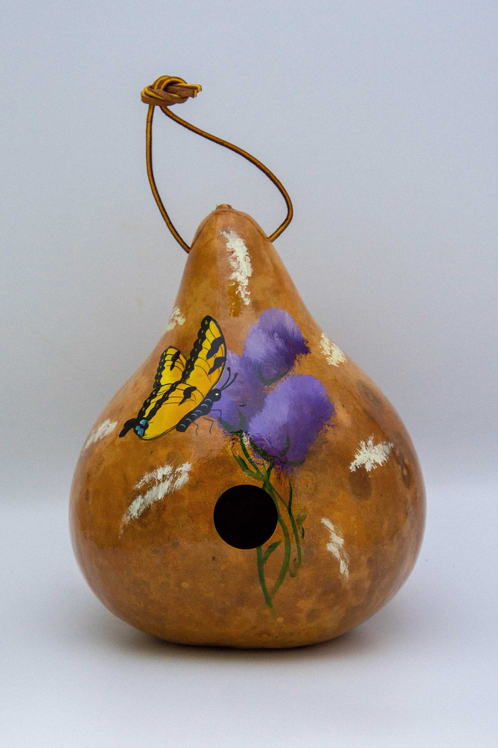 Side view of a natural gourd birdhouse with a 1.5-inch entry hole for wrens and chickadees.