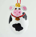 Painted egg gourd cow ornament with Holstein spots, gold cowbell, and red string hanging loop