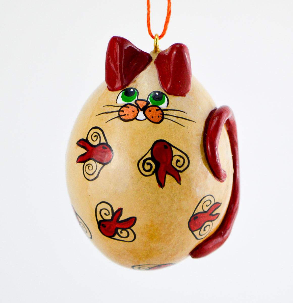 Whimsical calico cat gourd ornament with goldfish design and red accents hanging by orange cord