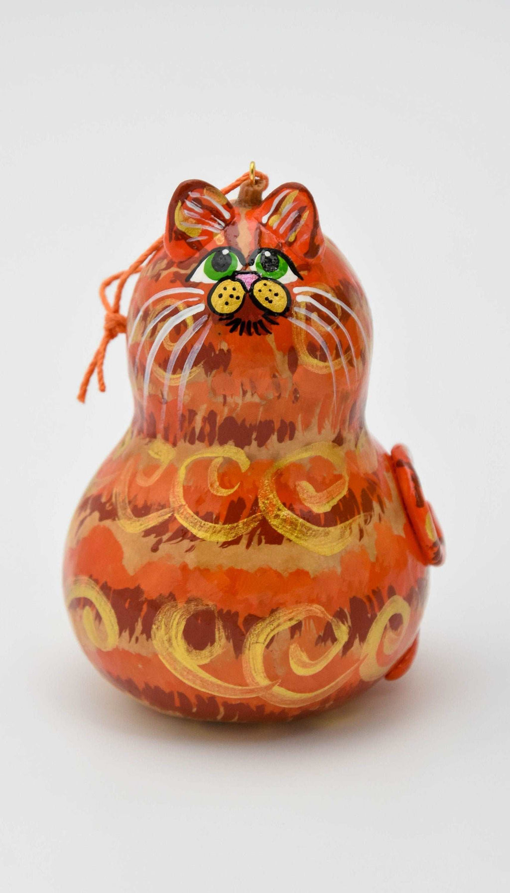 Orange tabby cat ornament made from a gourd with painted details and hanging cord