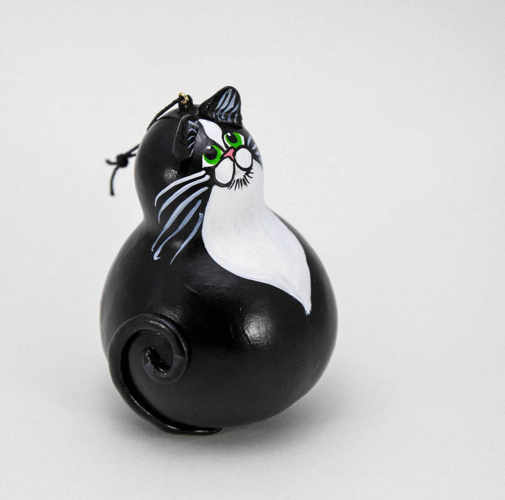 Hand-painted Tuxedo Cat Ornament made from dried gourd with green eyes and curled tail, ready to hang on tree