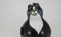 Hand-painted Tuxedo Cat Ornament made from dried gourd with green eyes and black and white tuxedo pattern, ready to hang.